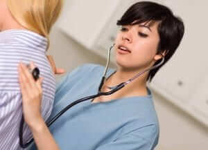 Vocational Nurse (VN) Nursing Program Student Listening to patient with stethoscope